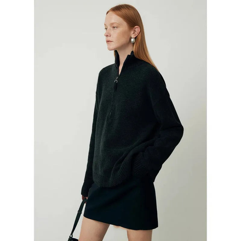 Loose-fit black wool bandage dress with long sleeves on a model.