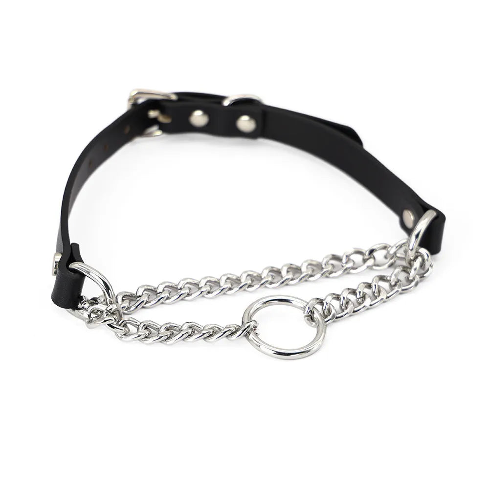 Black leather collar with chain detail and attached black leash on a dark background.