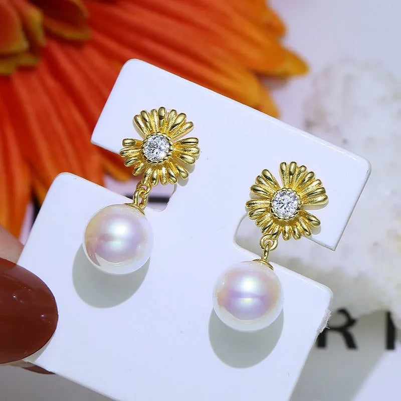 A pair of baroque-style flower drop earrings with intricate openwork, made from 925 sterling silver on a plain background.