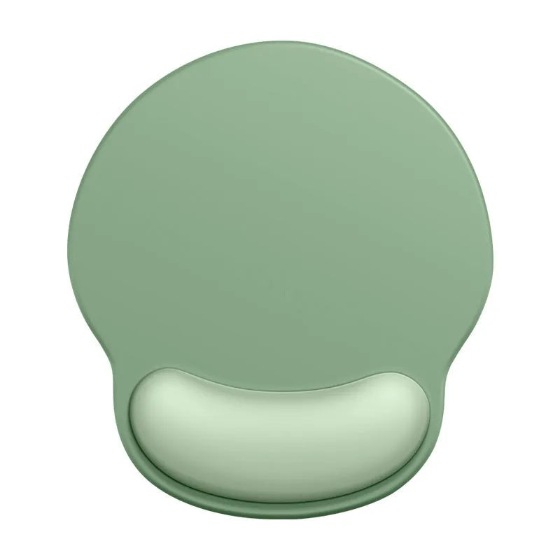 Silicone mouse mat with integrated wristband pad in a solid colour on a desk.