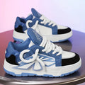 Men's white chunky sneakers with thick rubber sole and synthetic leather upper on a casual background.