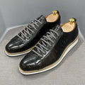 Men's low-top handmade shoes with embossed pattern on front, showing front-tie laces and grey colour.