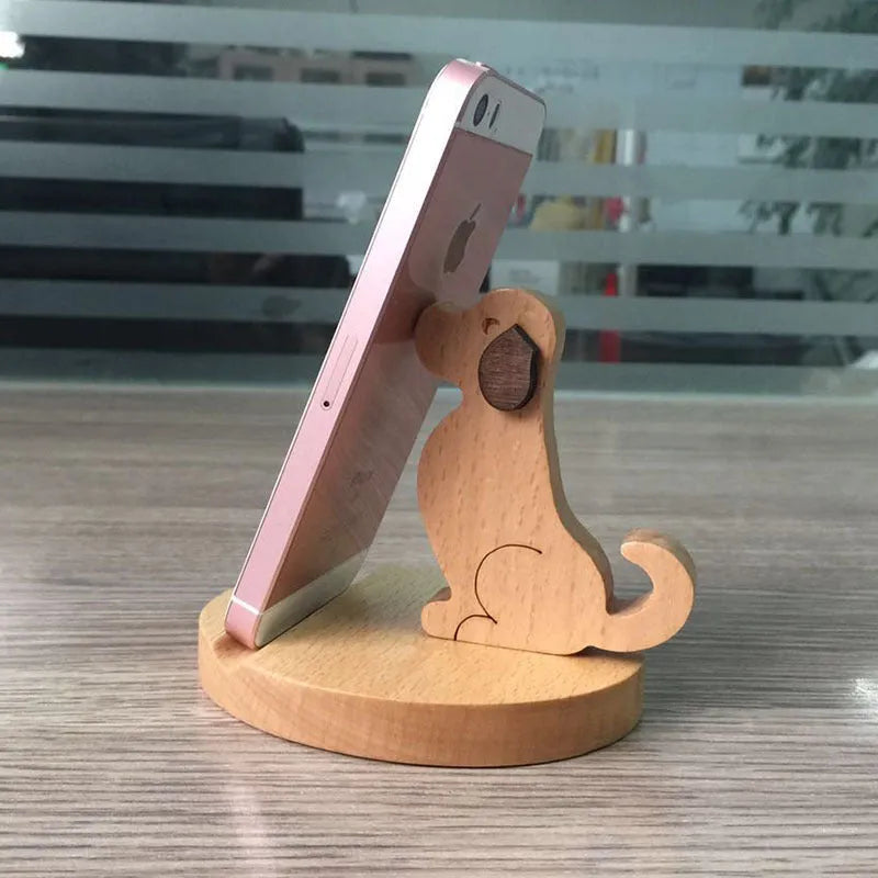 Brown solid wood desktop phone holder shaped like a cartoon puppy with spray paint finish