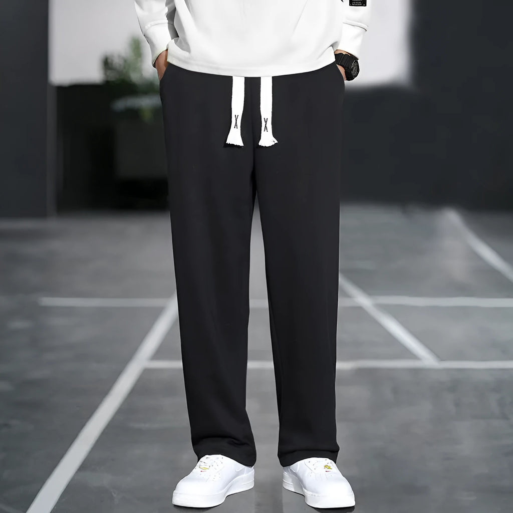 Men's grey Ninth Sports Pants showing high waist and multiple pockets.