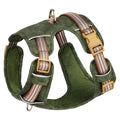 Brown leather dog harness with reflective strips and chest clip.