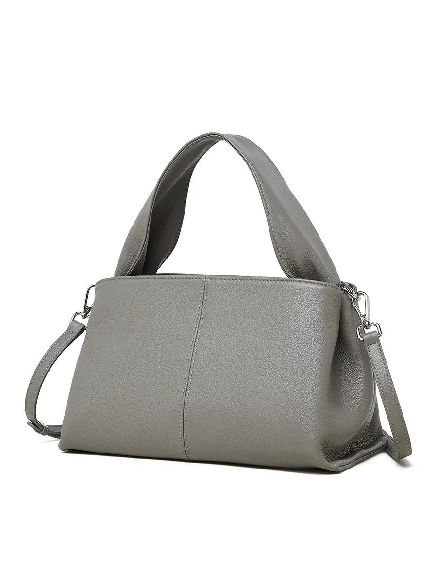 Women's genuine cowhide messenger bag with retro texture in horizontal square design showing shoulder straps and exterior pocket