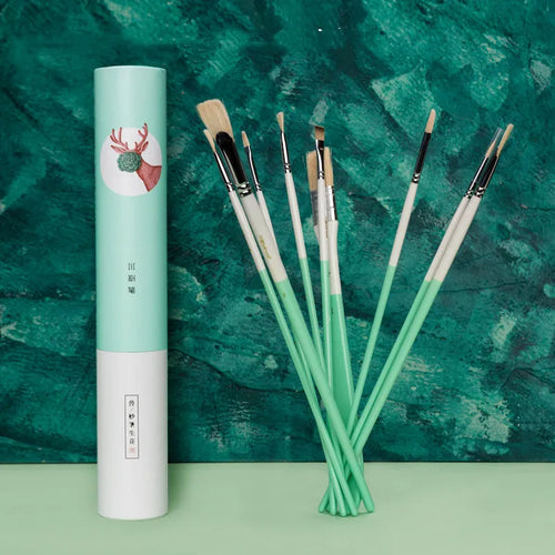 Acrylic gouache painting brush set with fan brushes, liner, and corner tools in animal designs on a table