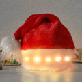 Red and white plush Santa hat with LED twinkling lights around brim and pom-pom