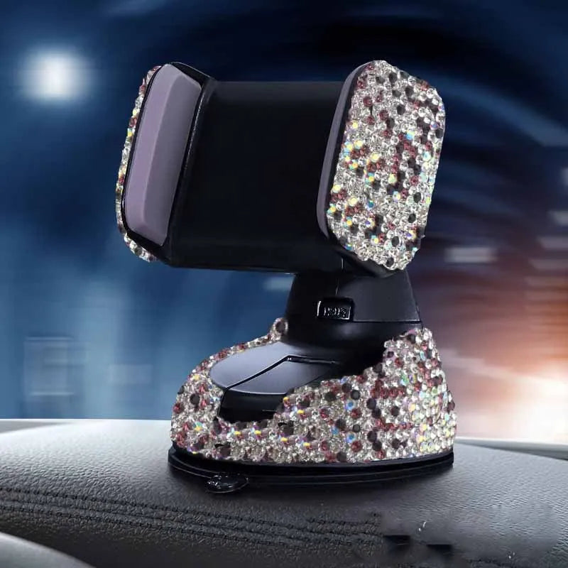 Diamond-encrusted car phone holder mounted on air vent with adjustable push-button mechanism and smartphone securely held