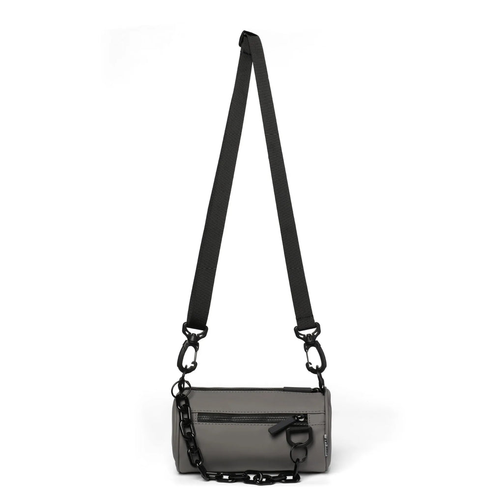 Black Oxford cloth messenger bag with a chain detail, worn crossbody.