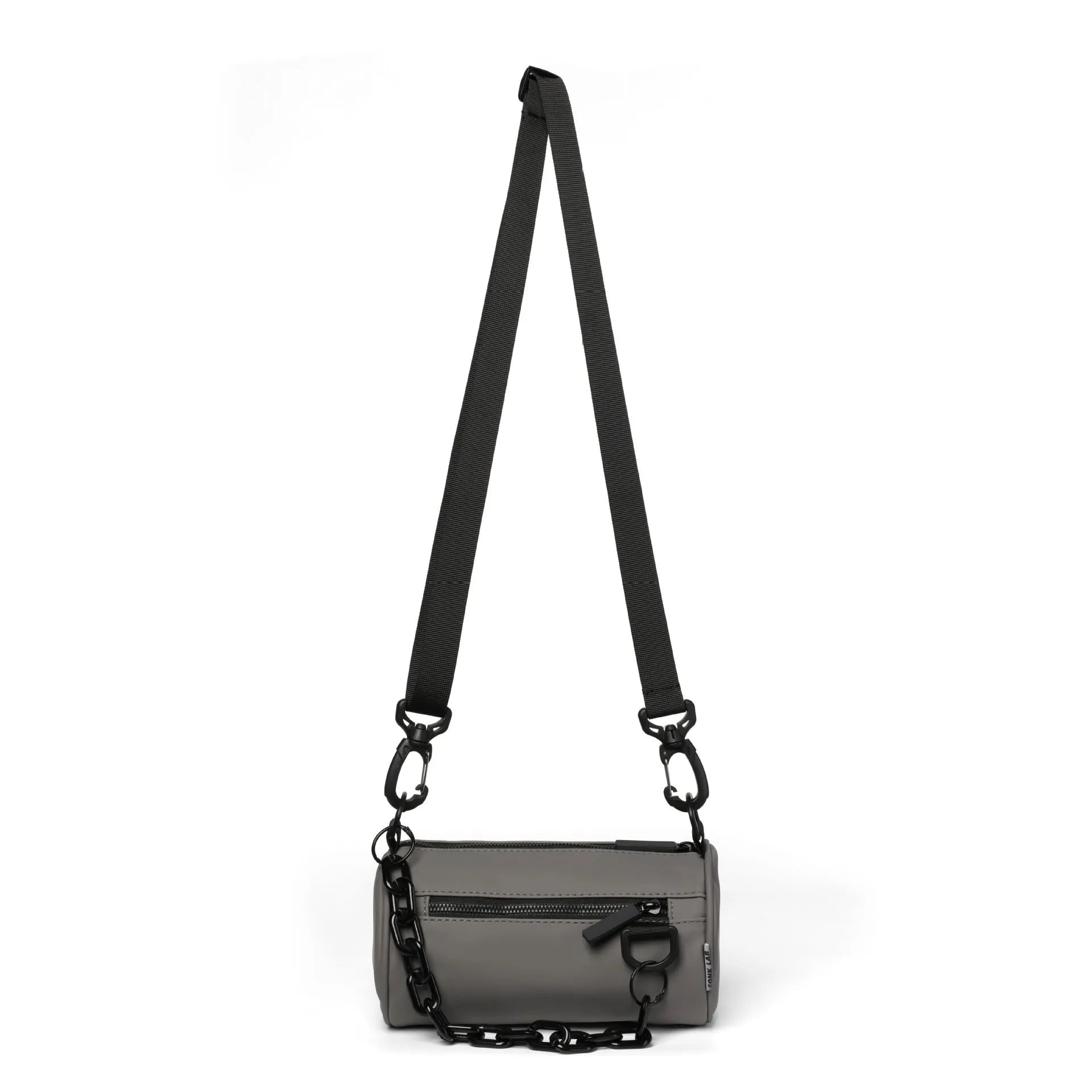 Black Oxford cloth messenger bag with a chain detail, worn crossbody.