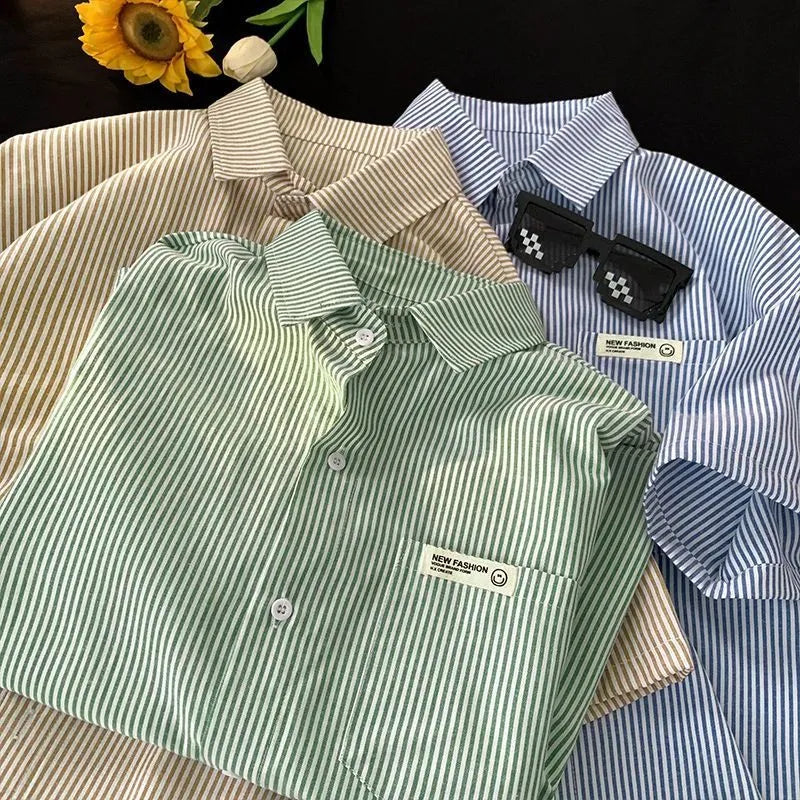 Blue and green striped loose fit plus size half sleeve shirt for women on a hanger