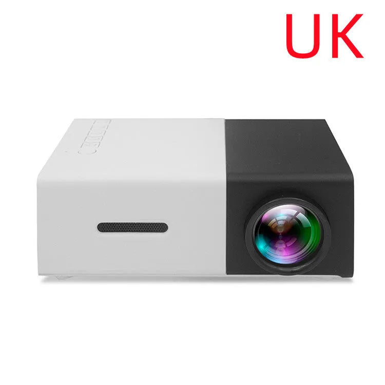 Mini LED projector YG300 in white and yellow, with lens and ventilation grilles, on a table