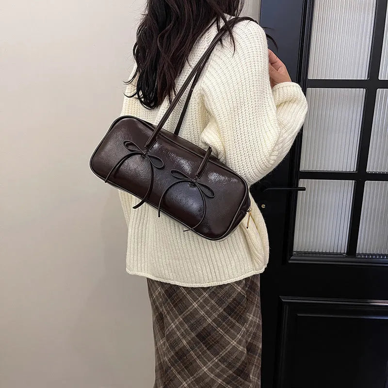 Soft PU pillow underarm bag in brown with bow, stitching and contrast colour details, large capacity women's daily matching bag