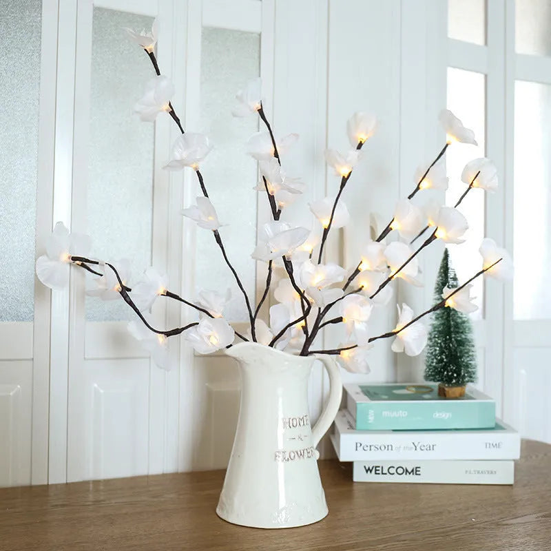 A 65cm tall pink LED phalaenopsis orchid branch light with fabric petals, powered by batteries.