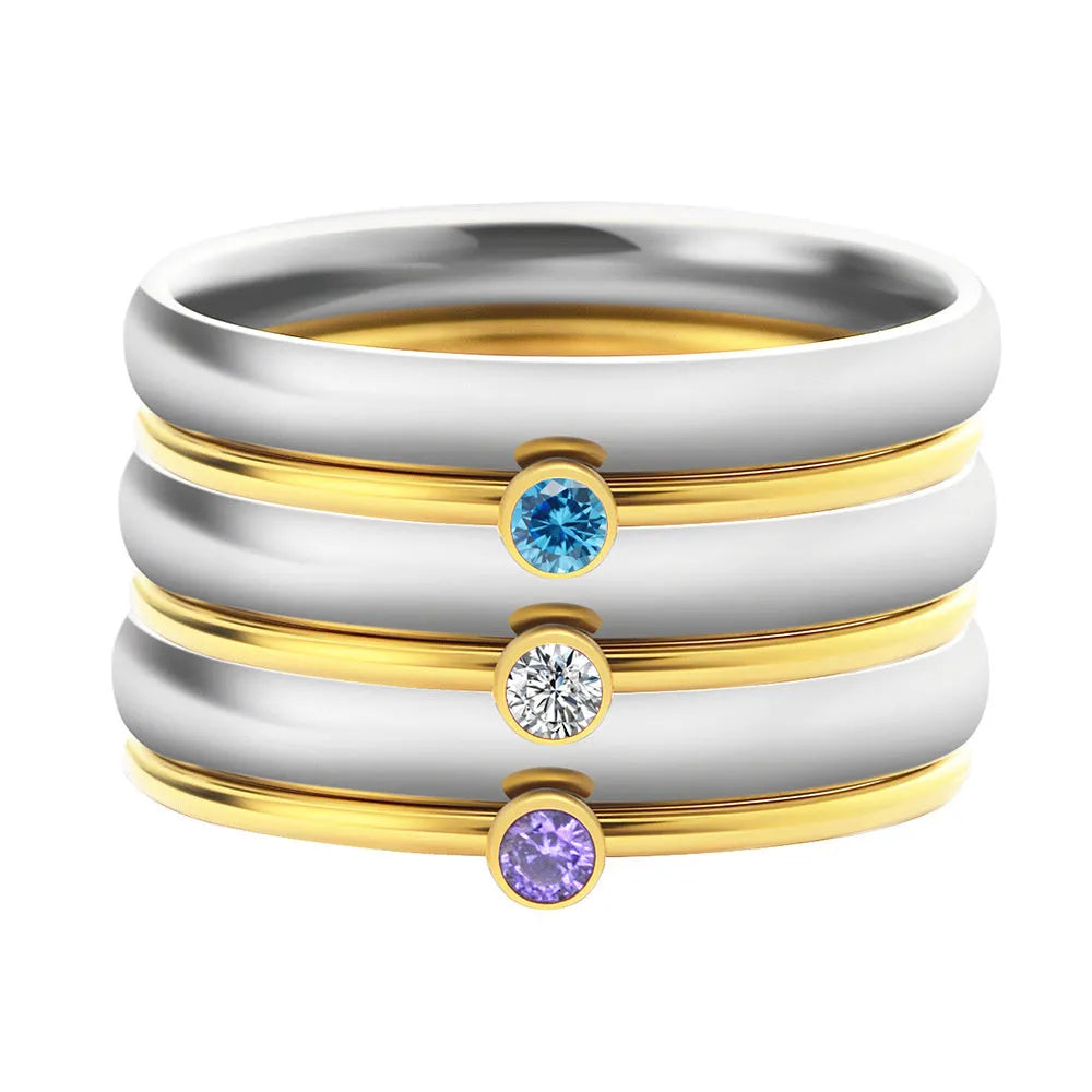 A geometric titanium steel ring with engraved details and a December birthstone colour accent.