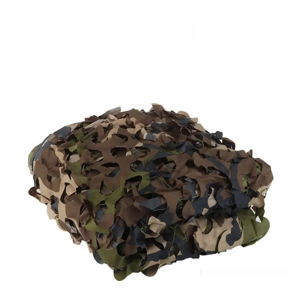 Green camouflage netting cover shown in a desert camouflage pattern, laid over outdoor terrain.