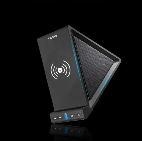 Black multifunctional power bank with integrated Bluetooth speaker and wireless charging phone stand on a desk.