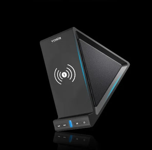 Black multifunctional power bank with integrated Bluetooth speaker and wireless charging phone stand on a desk.