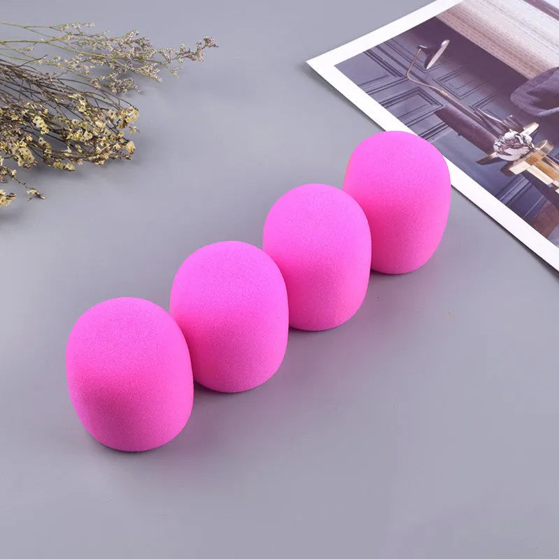 Four multicoloured foam microphone windshields for handheld stage microphones