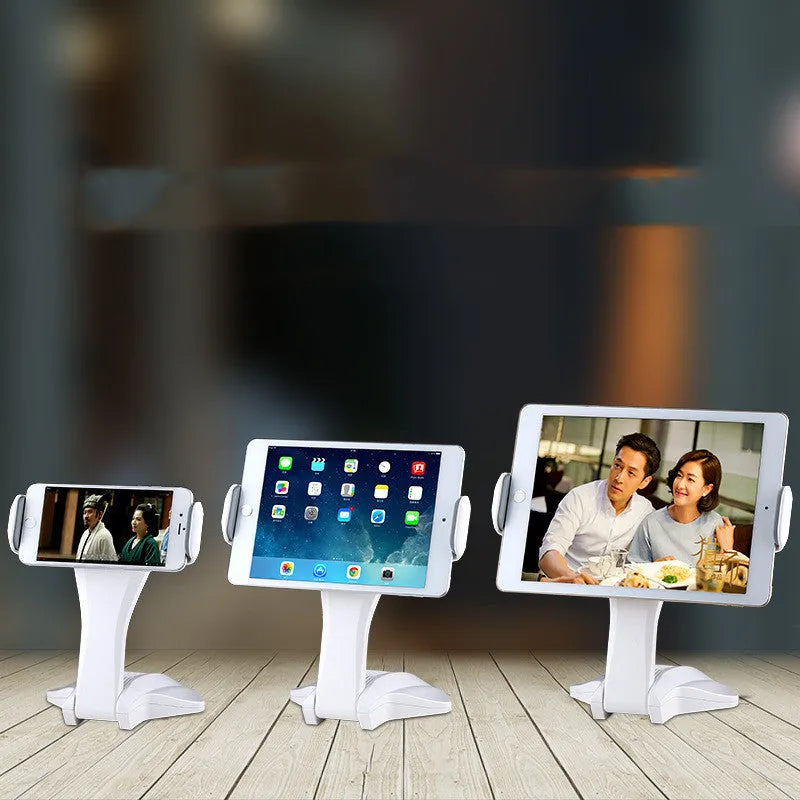 White foldable universal tablet stand with adjustable clamp extended, holding a tablet.