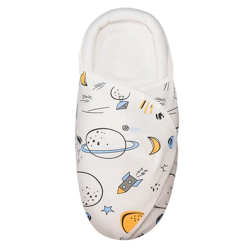 Cotton baby anti startle swaddle measuring 30 by 60 centimetres in a colourful print design.