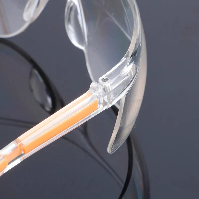 Transparent polycarbonate safety goggles with yellow tinted lenses for eye protection.