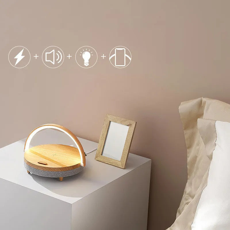 Wireless charging night light with Bluetooth speaker showing marble pattern finish and mobile phone resting in integrated holder
