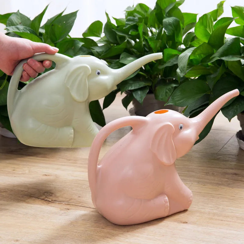 Pink baby elephant shaped plastic watering can with a long spout and bottle-style handle.