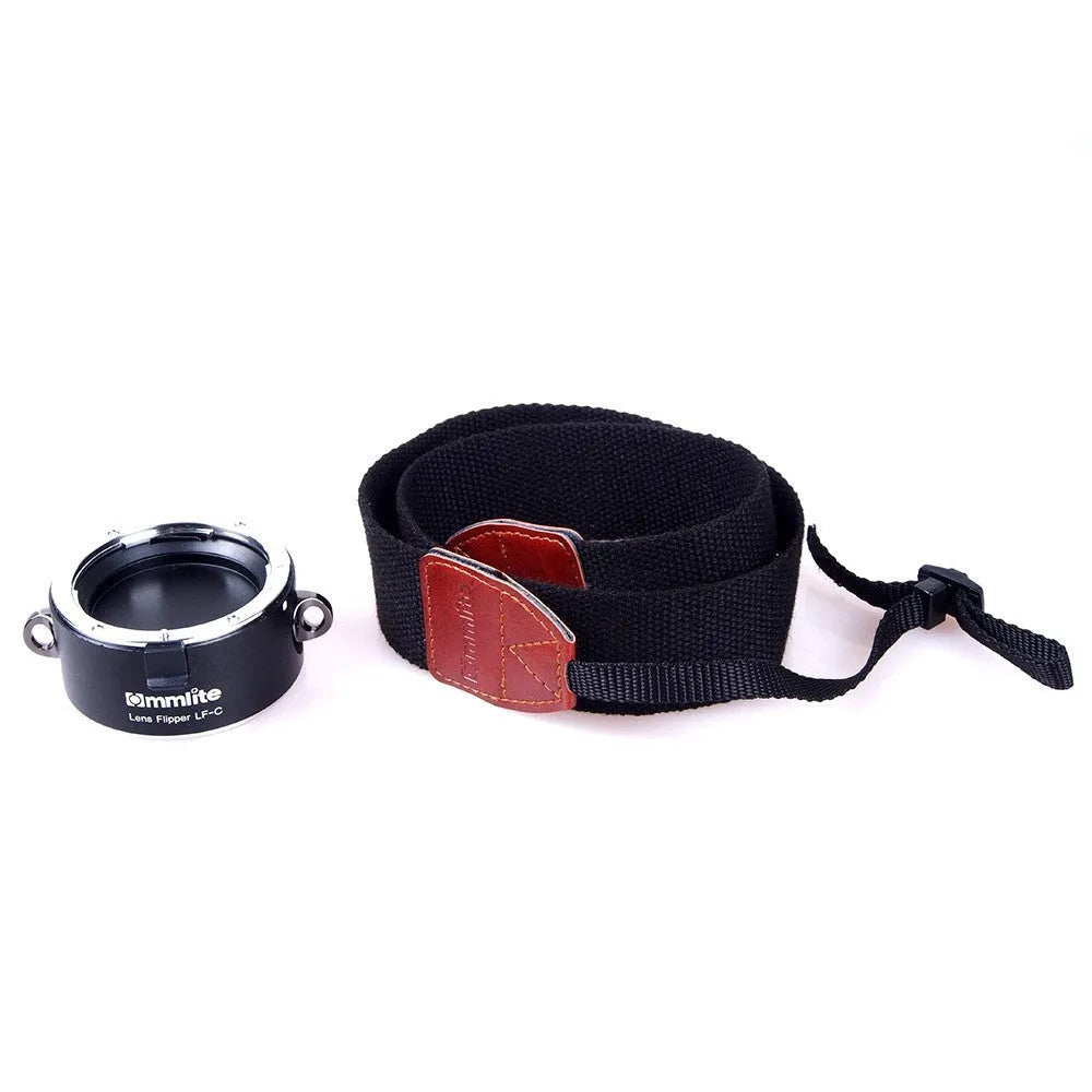 Aluminium camera lens flipper holder with two lenses attached on a cotton shoulder strap.