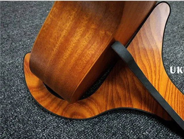 Wooden folding ukulele stand with EVA anti-slip foam holding a ukulele upright