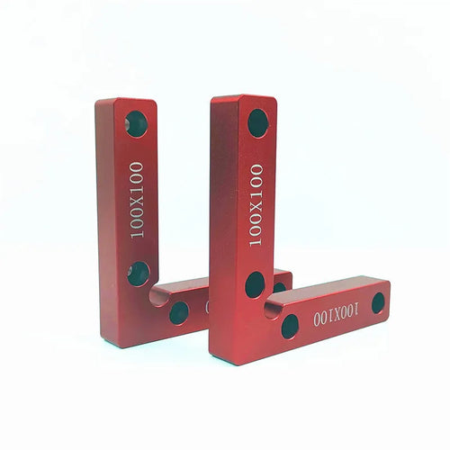 Silver aluminium right angle block clamped to a wooden workbench next to a jigsaw, showing scale markings.