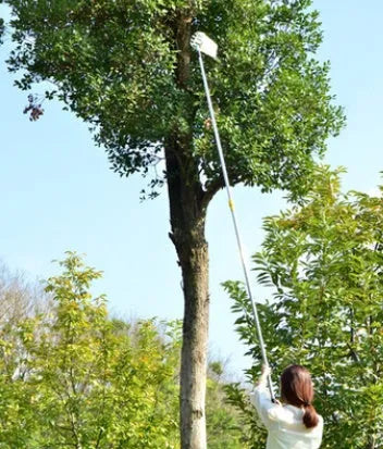 Silver metal fruit picker with 15cm cutting ring and cotton collection bag on a branch