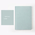 Blue A5 dotted notebook with soft imitation leather cover open to show dot grid pages