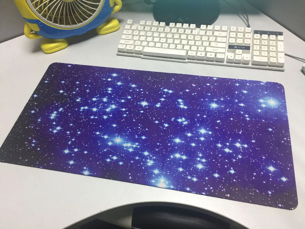 Blue star mouse pad with high-density fabric surface and anti-skid natural rubber base on a desk