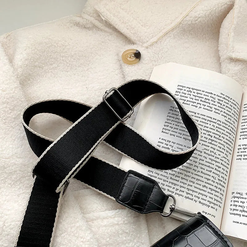 A PU fabric crossbody bag with an adjustable strap, shown in dark brown colour.