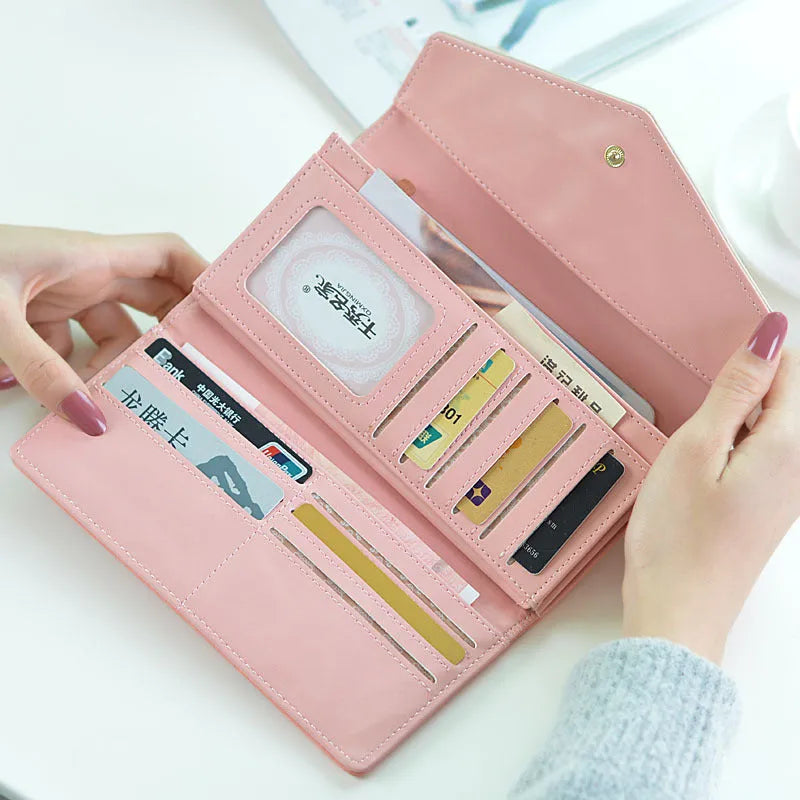 A women's large capacity three-fold PU leather wallet with a buckle, shown in one of five colours.