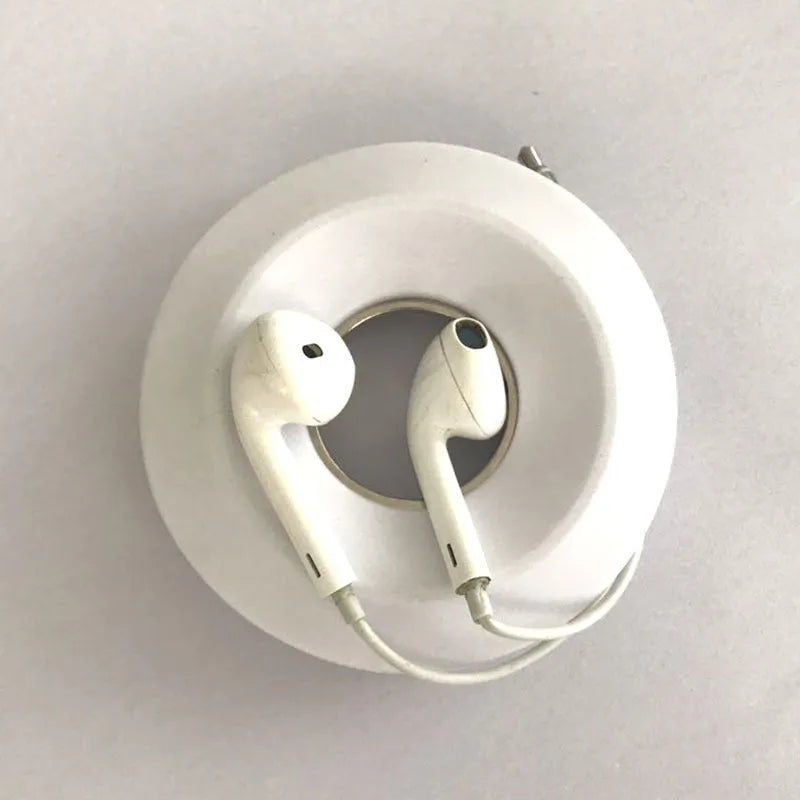 Silicone donut-shaped suction cup cord reel for organising phone and earphone cables