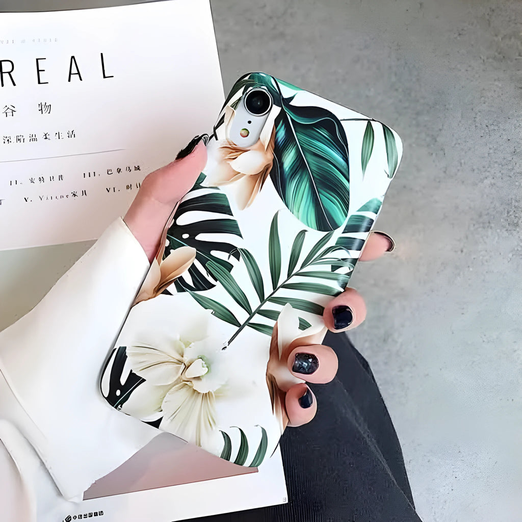 LOVECOM floral iPhone back case with banana leaf design on a smartphone.