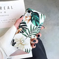 LOVECOM floral iPhone back case with banana leaf design on a smartphone.