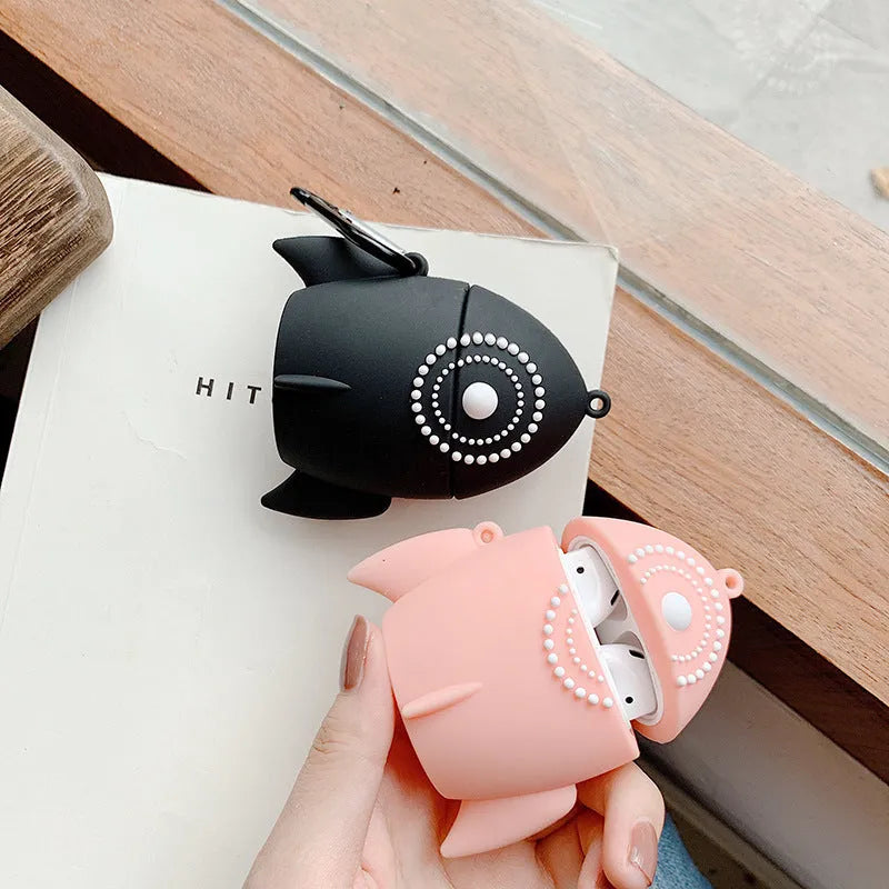 Pink silicone AirPods case with raised rocket design next to black plain version