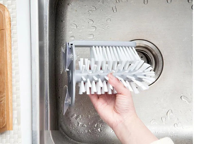 Grey rotating cup brush with dual heads and suction cups for wall mounting