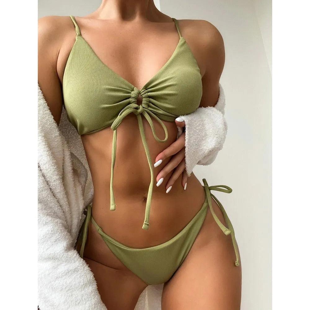 Women's solid colour drawstring bikini set in brief backless style on a neutral background.