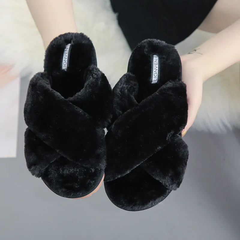 Women's black cross open-toe fur slippers on a white background, showing criss-cross upper and patterned sole.