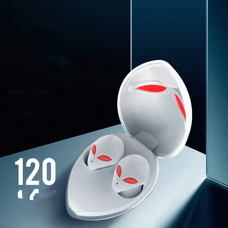 Creative Outer T8 Starman alien-shaped Bluetooth earbuds with LED lights next to their wireless charging case.