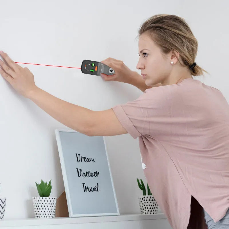 Red laser level and dust collection bracket mounted on an electric hammer drill.