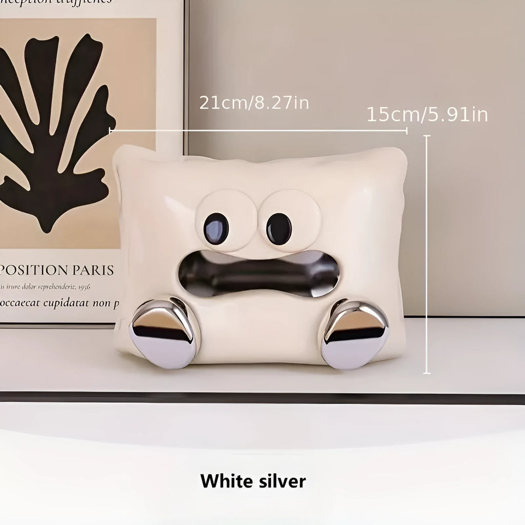 White ceramic tissue box with a smooth, glazed finish on a wooden coffee table.
