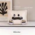 White ceramic tissue box with a smooth, glazed finish on a wooden coffee table.