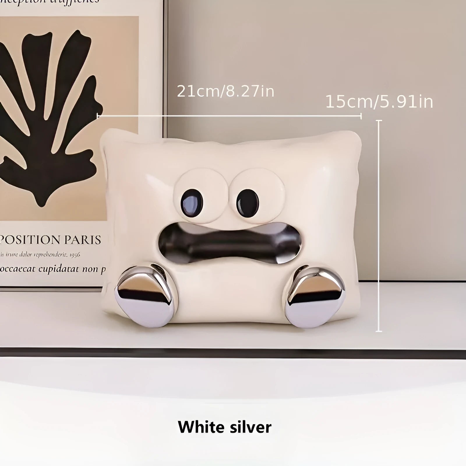 White ceramic tissue box with a smooth, glazed finish on a wooden coffee table.