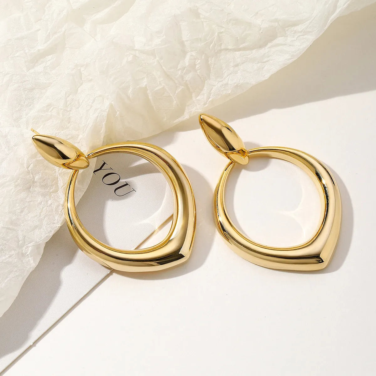 Pair of copper earrings with love heart motif and tassel drop in gold colour